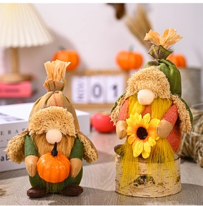 Detail of autumn gnomes featuring a knitted hat with pumpkin and sunflower accents