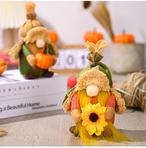 Close-up of autumn gnomes with pumpkin and sunflower accents for Thanksgiving home decor