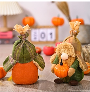 Detail of harvest gnomes with orange felt body, plaid hat and mini pumpkin decor