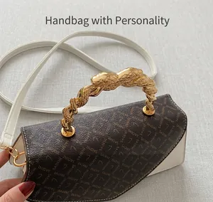 Detail of elegant white handbag with vintage pattern flap and gold snake metal handle