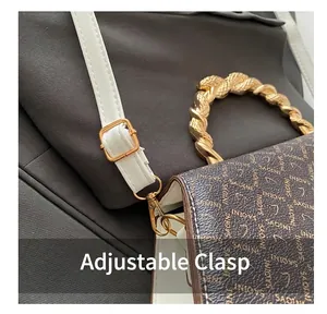 Close-up of golden adjustment buckle and rope handle on retro patterned handbag