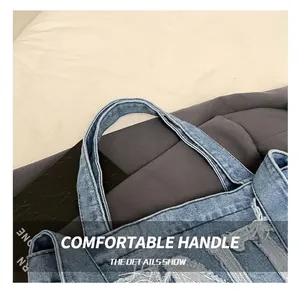 Close-up of durable reinforced handle and frayed edges on denim tote bag