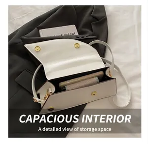 White faux leather crossbody bag interior showing phone and wallet storage capacity