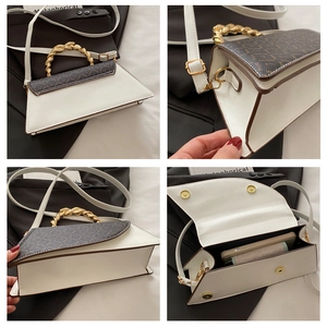 Detail view of leopard print shoulder bag with gold metal handle and interior compartments