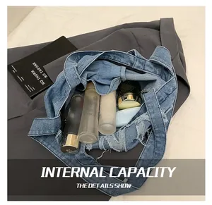 Internal capacity of denim tote bag with frayed edges and cosmetic bottles
