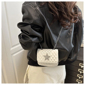 Vue de dos d'un modèle portant un sac matelassé blanc avec un ornement étoile brillant