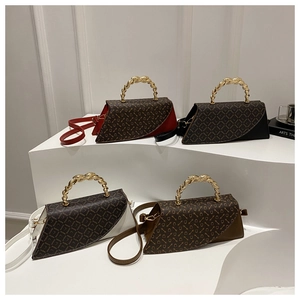 Detail of colorful trapezoid crossbody bags with SADINY logo and twisted gold handles