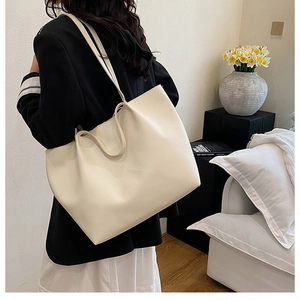 Minimalist cream tote bag styled in a bright modern home setting for daily commute use