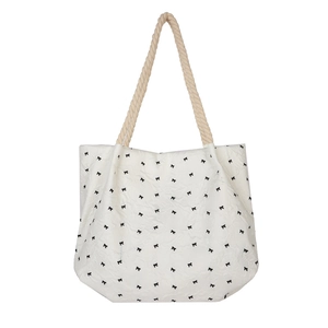 Chic cream tote bag with black bow print and rope handles for summer casual style