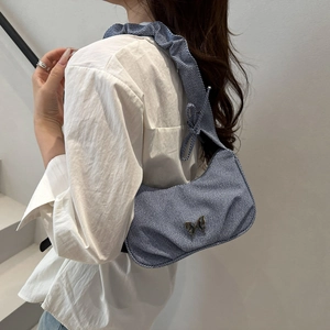 Blue and white striped underarm bag with metal butterfly and ruched shoulder strap