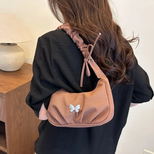 Brown textured fabric hobo bag with silver butterfly accent and ruffled shoulder strap