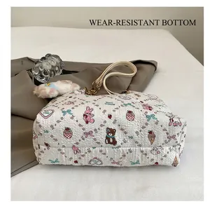 Detail of printed waffle fabric tote bag showing durable bottom and cute cartoon patterns