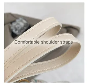 Detail of beige faux leather shoulder strap with reinforced double stitching craft