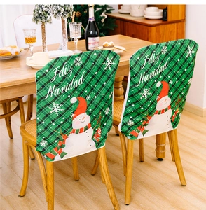 Detail of green plaid Christmas chair cover with cute snowman and Feliz Navidad text