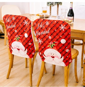 Christmas chair cover with Santa Claus and red plaid design in a cozy dining setting