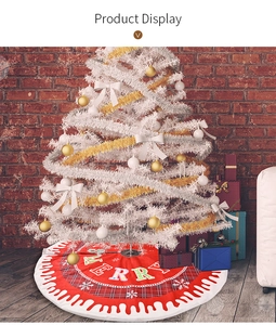Detail of red Christmas tree skirt with plaid edges and festive Merry typography