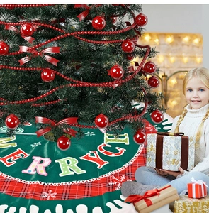 Detail of forest green Christmas tree skirt with red plaid border and Merry letters