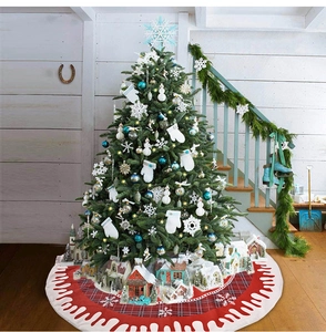 Detail of red and black plaid Christmas tree skirt with white snowflakes and wavy border