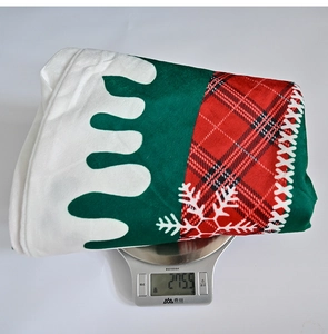 Detailed view of plaid Christmas tree skirt weighing 275.5g on a digital scale
