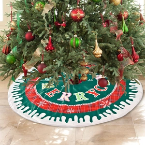 Green and red plaid Christmas tree skirt with Merry text and white snowflake patterns