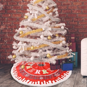 Red Christmas tree skirt with Merry text and snowflake patterns on wooden floor