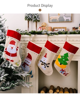 Set of 4 Christmas stockings with festive embroidery hanging on a white fireplace