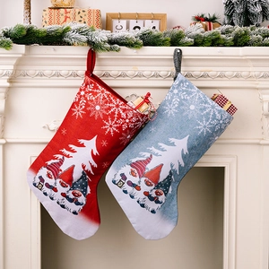 Detail of Christmas gnomes printed on linen stockings hanging by a white fireplace
