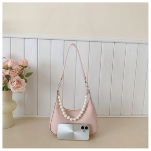Pink crescent underarm bag with pearl chain and mobile phone for size comparison