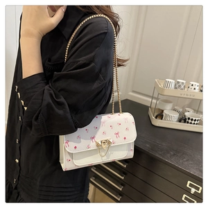 Detailed view of the double-layer interior and golden chain on the floral mini bag