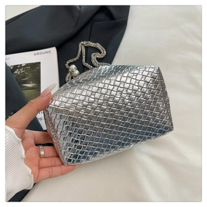 Detail of silver metallic woven handbag with elegant metal chain and pearl accents