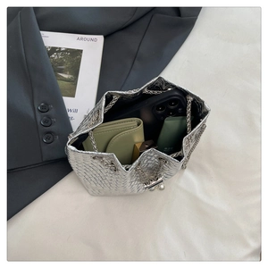Detailed top view of silver woven bucket bag showing interior space and chain strap