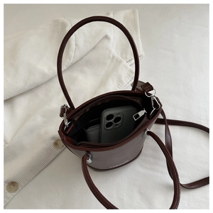 Top-down view of a vintage dark brown bucket bag interior showing daily storage space