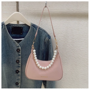 Pink hobo bag with large pearl chain and gold-stamped logo on smooth leather finish
