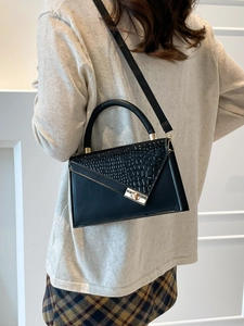 Elegant black crocodile-pattern handbag with top handle and gold clasp for women