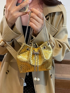 Golden metallic woven bucket bag with pearl charm and silver chain strap for women