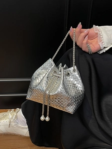 Silver metallic woven bucket bag with chain strap and pearl drawstring details