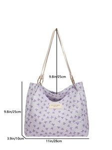 Light purple tote bag with purple bow pattern and off-white canvas shoulder strap