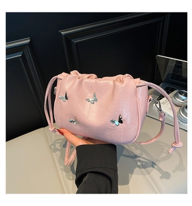 Pink pleated bucket bag detail featuring four silver metallic butterfly charms