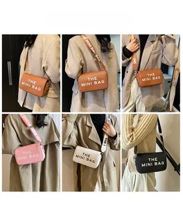 Detail of the mini crossbody bag with wide strap and THE MINI BAG lettering in 4 colors