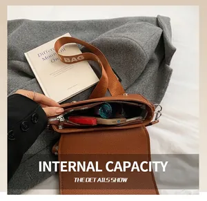 Internal view of brown textured leather crossbody bag showing large capacity for essentials