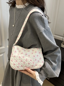 Sac à bandoulière blanc avec motif nœuds roses et texture matelassée pour femmes
