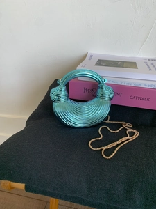 Glossy teal metallic half-moon handbag with 3D wave texture and gold chain strap