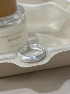 Macro shot of silver butterfly ring with matte brushed finish and adjustable band detail