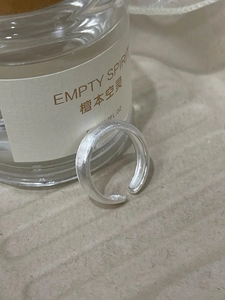 Close-up of matte brushed silver adjustable open ring with minimalist metal texture