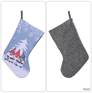 Front and back view of blue Christmas stocking with gnome print and dark felt back