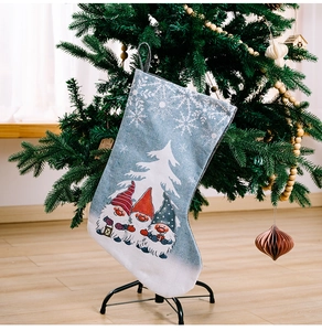 Detail of Christmas stocking featuring three Nordic gnomes with snowflakes and hanging loop