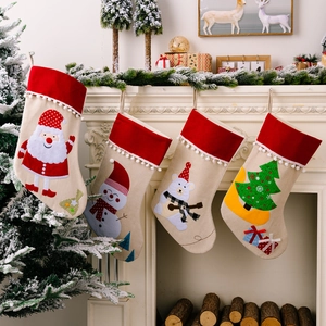 Set of four Christmas stockings with festive embroidery hanging on a white fireplace