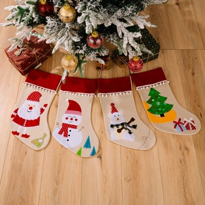 Set of 4 festive Christmas stockings featuring Santa, snowman, bear, and tree motifs