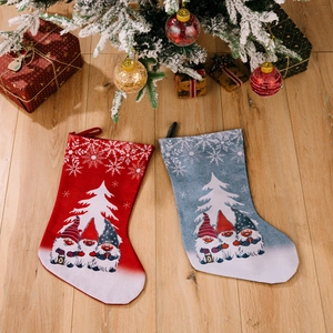Red and blue Rudolf gnome print Christmas stockings hanging under a festive tree