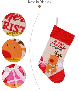 Detail of Christmas stocking with reindeer embroidery and Merry Christmas text on linen fabric